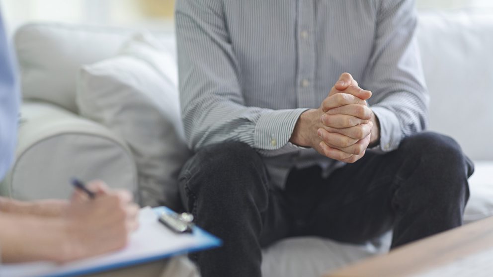 Man sitting on couch with counselor